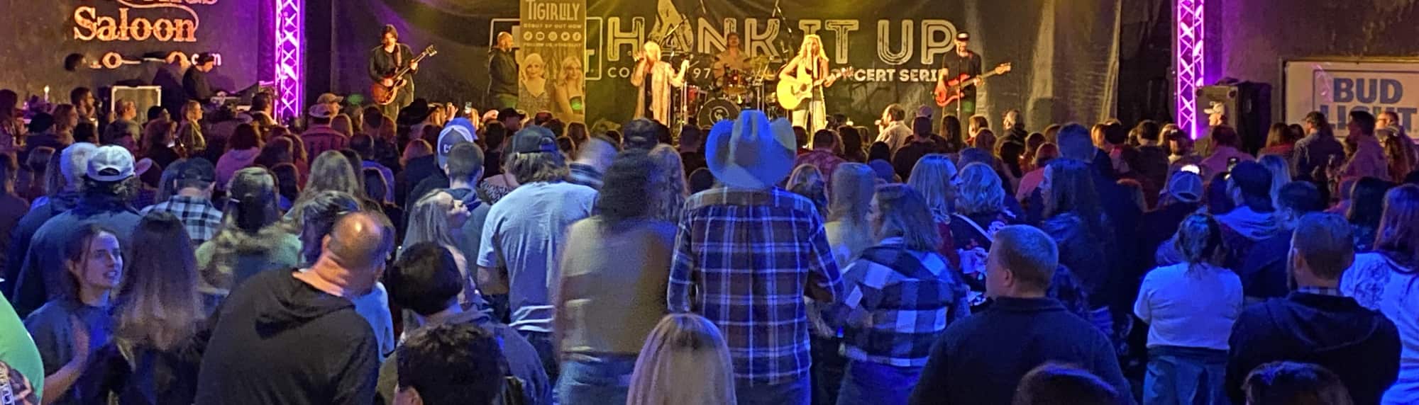 country concert with fans wearing cowboy hats Las Vegas